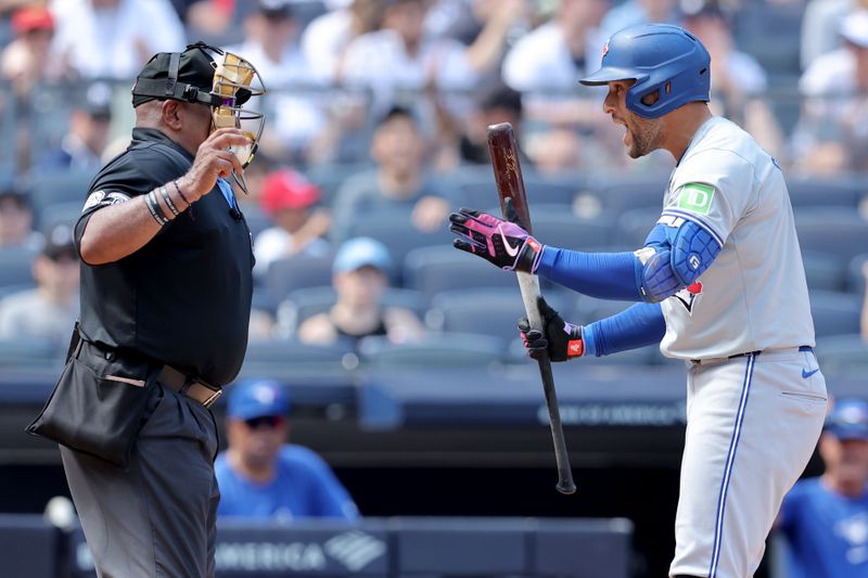 Aug 3, 2024; Bronx, New York, USA; Toronto Blue Jays designated hitter George Springer (4) reacts after striking out on a called third strike by home plate umpire Laz Diaz (63) during the seventh inning against the New York Yankees at Yankee Stadium. Mandatory Credit: Brad Penner-USA TODAY Sports