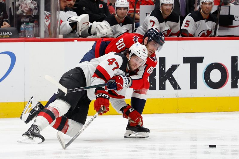 Oct 12, 2024; Washington, District of Columbia, USA; New Jersey Devils center Paul Cotter (47) and Washington Capitals left wing Pierre-Luc Dubois (80) battle for the puck in the third period at Capital One Arena. Mandatory Credit: Geoff Burke-Imagn Images