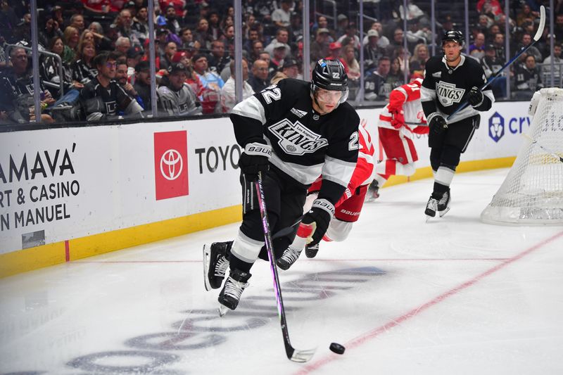 Oct 30, 2025; Los Angeles, California, USA; Los Angeles Kings left wing Kevin Fiala (22) moves the puck ahead of Detroit Red Wings left wing Lucas Raymond (23) during the first period at Crypto.com Arena. Mandatory Credit: Gary A. Vasquez-Imagn Images