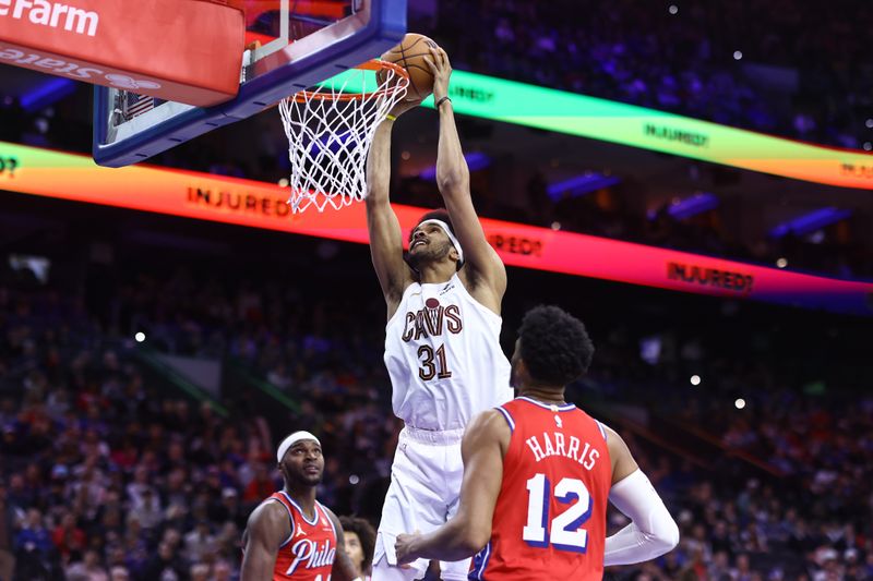 PHILADELPHIA, PENNSYLVANIA - FEBRUARY 23: Jarrett Allen #31 of the Cleveland Cavaliers dunks between Paul Reed #44 and Tobias Harris #12 of the Philadelphia 76ers during the third quarter at the Wells Fargo Center on February 23, 2024 in Philadelphia, Pennsylvania. (Photo by Tim Nwachukwu/Getty Images)