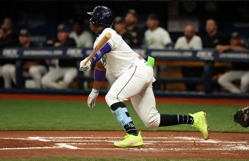 May 10, 2024; St. Petersburg, Florida, USA; Tampa Bay Rays first base Yandy Díaz (2) singles against the New York Yankees during the first inning at Tropicana Field. Mandatory Credit: Kim Klement Neitzel-USA TODAY Sports