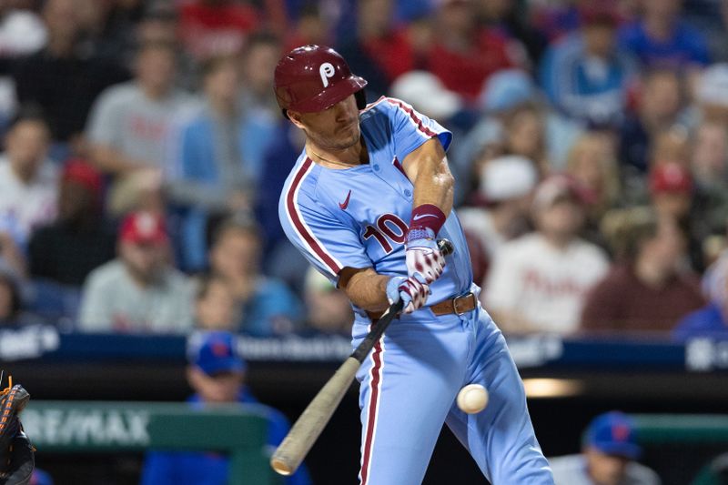 May 16, 2024; Philadelphia, Pennsylvania, USA; Philadelphia Phillies catcher J.T. Realmuto (10) hits a single during the sixth inning against the New York Mets at Citizens Bank Park. Mandatory Credit: Bill Streicher-USA TODAY Sports