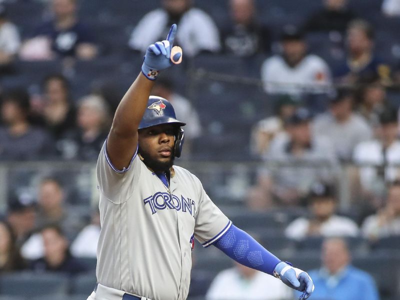 Apr 13, 2022; Bronx, New York, USA;  Toronto Blue Jays first baseman Vladimir Guerrero Jr. (27) points to his teammates after hitting a solo home run in the first inning against the New York Yankees at Yankee Stadium. Mandatory Credit: Wendell Cruz-USA TODAY Sports