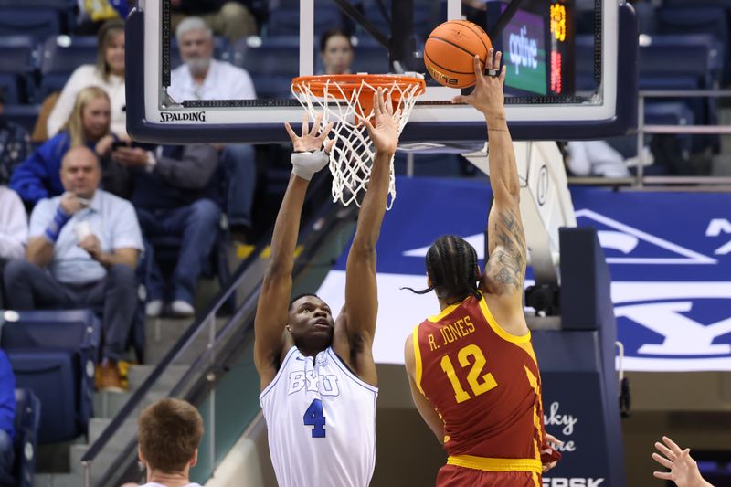 Jan 16, 2024; Provo, Utah, USA; Iowa State Cyclones forward Robert Jones (12) shoots the ball over Brigham Young Cougars forward Atiki Ally Atiki (4) during the first half at Marriott Center. Mandatory Credit: Rob Gray-USA TODAY Sports