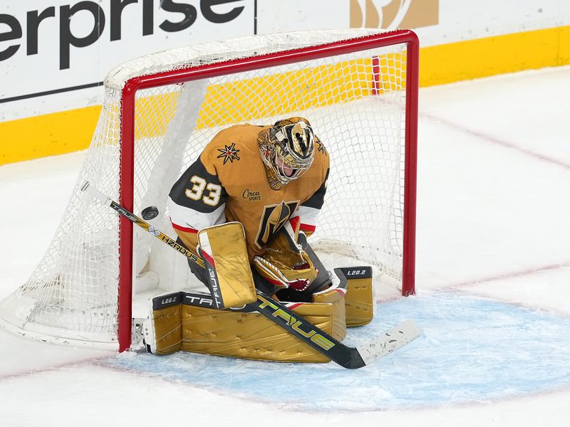 Feb 16, 2023; Las Vegas, Nevada, USA; Vegas Golden Knights goaltender Adin Hill (33) makes a save against the San Jose Sharks during the third period at T-Mobile Arena. Mandatory Credit: Stephen R. Sylvanie-USA TODAY Sports