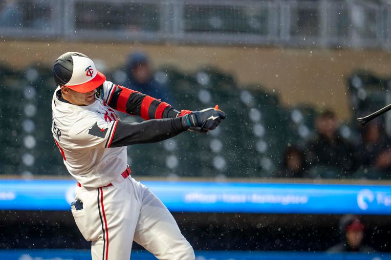 May 19, 2025; Minneapolis, Minnesota, USA; Minnesota Twins right fielder Carson McCusker (60) loses his bat during a swing against the Cleveland Guardians in the second inning  at Target Field. Mandatory Credit: Jesse Johnson-Imagn Images