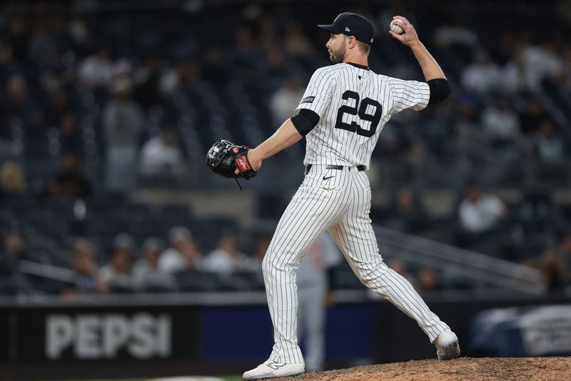 Sep 10, 2025; Bronx, New York, USA; New York Yankees left fielder Austin Slater (29) delivers a pitch during the ninth inning against the Detroit Tigers at Yankee Stadium. Mandatory Credit: Vincent Carchietta-Imagn Images