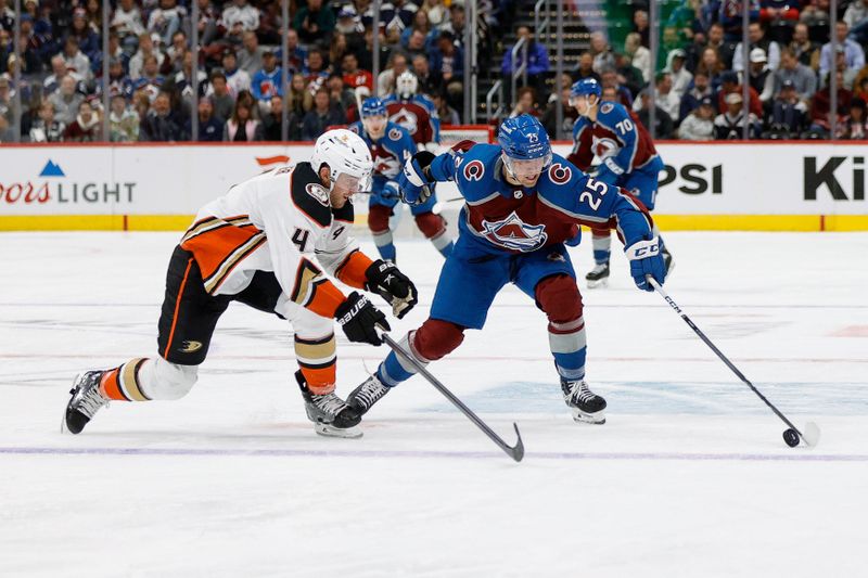 Dec 5, 2023; Denver, Colorado, USA; Colorado Avalanche right wing Logan O'Connor (25) controls the puck under pressure from Anaheim Ducks defenseman Cam Fowler (4) in the second period at Ball Arena. Mandatory Credit: Isaiah J. Downing-USA TODAY Sports