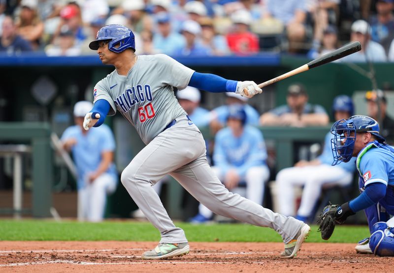 Jul 28, 2024; Kansas City, Missouri, USA; Chicago Cubs catcher Christian Bethancourt (60) hits a double against the Kansas City Royals during the fifth inning at Kauffman Stadium. Mandatory Credit: Jay Biggerstaff-USA TODAY Sports