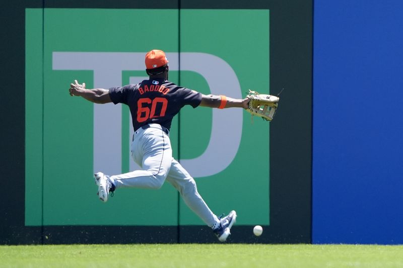 Mar 23, 2024; Dunedin, Florida, USA; Detroit Tigers centerfielder Akil Baddoo (60) misses a ball hit by Toronto Blue Jays shortstop Isiah Kiner-Falefa (7) during the third inning at TD Ballpark. Mandatory Credit: Dave Nelson-USA TODAY Sports