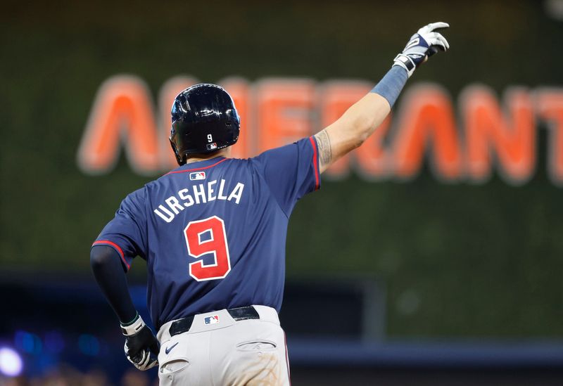 Sep 21, 2024; Miami, Florida, USA;  Atlanta Braves third baseman Gio Urshela (9) reacts after hitting a home run against the Miami Marlins in the seventh inning at loanDepot Park. Mandatory Credit: Rhona Wise-Imagn Images