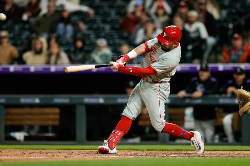 May 19, 2025; Denver, Colorado, USA; Philadelphia Phillies designated hitter Kyle Schwarber (12) hits a solo home run in the ninth inning against the Colorado Rockies at Coors Field. Mandatory Credit: Isaiah J. Downing-Imagn Images