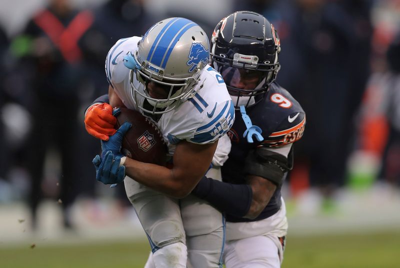 Chicago Bears safety Jaquan Brisker (9) tackles Detroit Lions wide receiver Kalif Raymond (11) during an NFL football game, Sunday, Dec. 10, 2023, in Chicago. (AP Photo/Melissa Tamez)