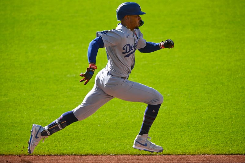 May 26, 2025; Cleveland, Ohio, USA; Los Angeles Dodgers shortstop Mookie Betts (50) runs to first base in the first inning against the Cleveland Guardians at Progressive Field. Mandatory Credit: David Richard-Imagn Images