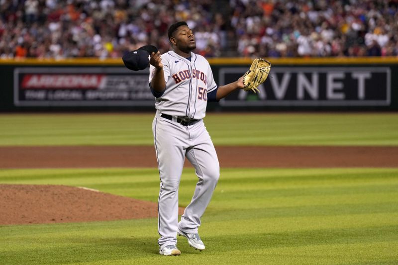 Sep 30, 2023; Phoenix, Arizona, USA; Houston Astros relief pitcher Hector Neris (50) reacts after retiring the side against the Arizona Diamondbacks during the seventh inning at Chase Field. Mandatory Credit: Joe Camporeale-USA TODAY Sports