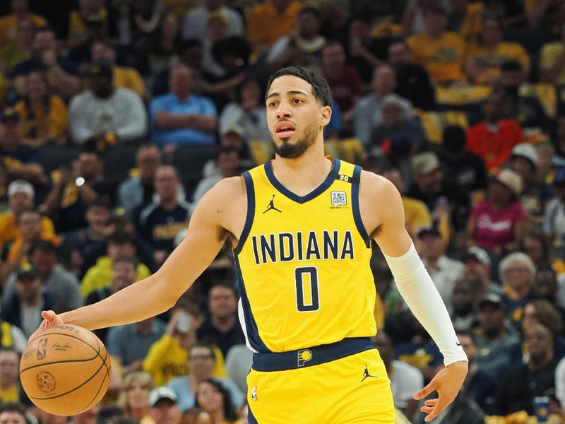 INDIANAPOLIS, IN - APRIL 28: Tyrese Haliburton #0 of the Indiana Pacers brings the ball up court during the game against the Milwaukee Bucks during Round 1 Game 4 of the 2024 NBA Playoffs on April 28, 2024 at Gainbridge Fieldhouse in Indianapolis, Indiana. NOTE TO USER: User expressly acknowledges and agrees that, by downloading and or using this Photograph, user is consenting to the terms and conditions of the Getty Images License Agreement. Mandatory Copyright Notice: Copyright 2024 NBAE (Photo by Ron Hoskins/NBAE via Getty Images)