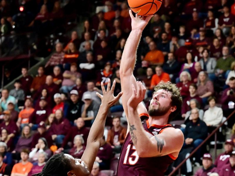 Feb 15, 2025; Blacksburg, Virginia, USA; Virginia Tech Hokies forward Ben Burnham (13) shoots the ball over Virginia Cavaliers guard Dai Dai Ames (7) during the first half at Cassell Coliseum. Mandatory Credit: Brian Bishop-Imagn Images