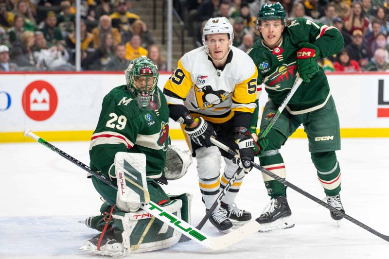 Feb 9, 2024; Saint Paul, Minnesota, USA; Pittsburgh Penguins left wing Jake Guentzel (59), Minnesota Wild goaltender Marc-Andre Fleury (29) and defenseman Brock Faber (7) follow the puck in the first period at Xcel Energy Center. Mandatory Credit: Matt Blewett-USA TODAY Sports