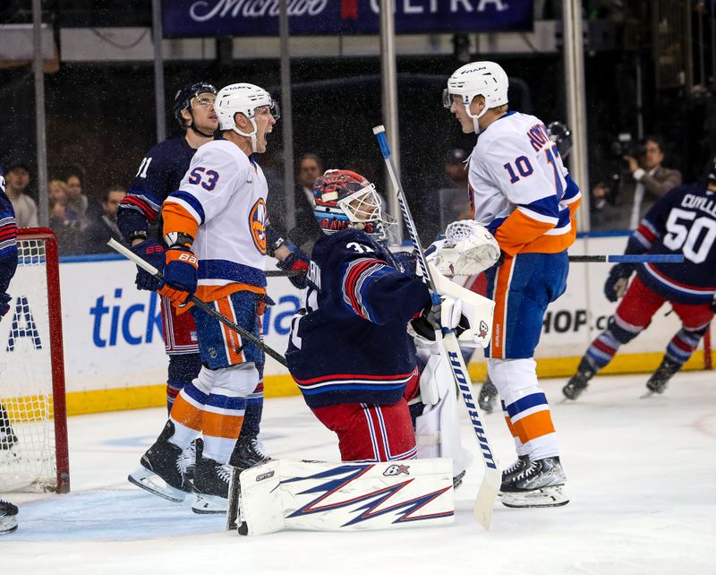 Nov 3, 2024; New York, New York, USA; New York Islanders center Casey Cizikas (53) celebrates his goal on New York Rangers goalie Igor Shesterkin (31) with New York Islanders right wing Simon Holmstrom (10) during the second period at Madison Square Garden. Mandatory Credit: Danny Wild-Imagn Images