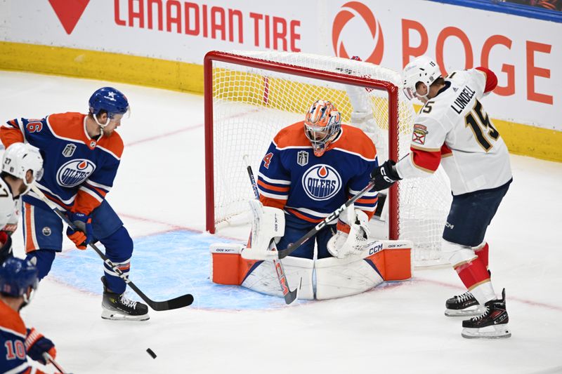June 21, 2024; Edmonton, Alberta, CAN; Florida Panthers center Anton Lundell (15) looks for the puck with Edmonton Oilers defenseman Philip Broberg (86) and Edmonton Oilers goaltender Stuart Skinner (74) in the first period in game six of the 2024 Stanley Cup Final at Rogers Place. Mandatory Credit: Walter Tychnowicz-USA TODAY Sports