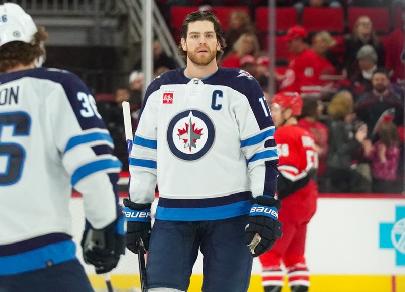 Mar 2, 2024; Raleigh, North Carolina, USA;  Winnipeg Jets center Adam Lowry (17) looks on during the warmups before the game against the Carolina Hurricanes at PNC Arena. Mandatory Credit: James Guillory-USA TODAY Sports
