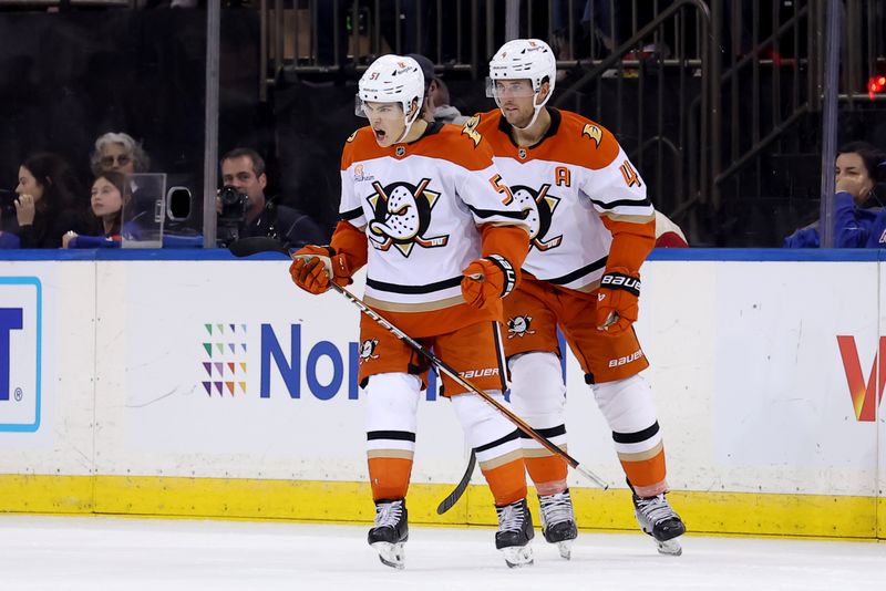 Oct 26, 2024; New York, New York, USA; Anaheim Ducks defenseman Olen Zellweger (51) celebrates his goal against the New York Rangers with defenseman Cam Fowler (4) during the third period at Madison Square Garden. Mandatory Credit: Brad Penner-Imagn Images