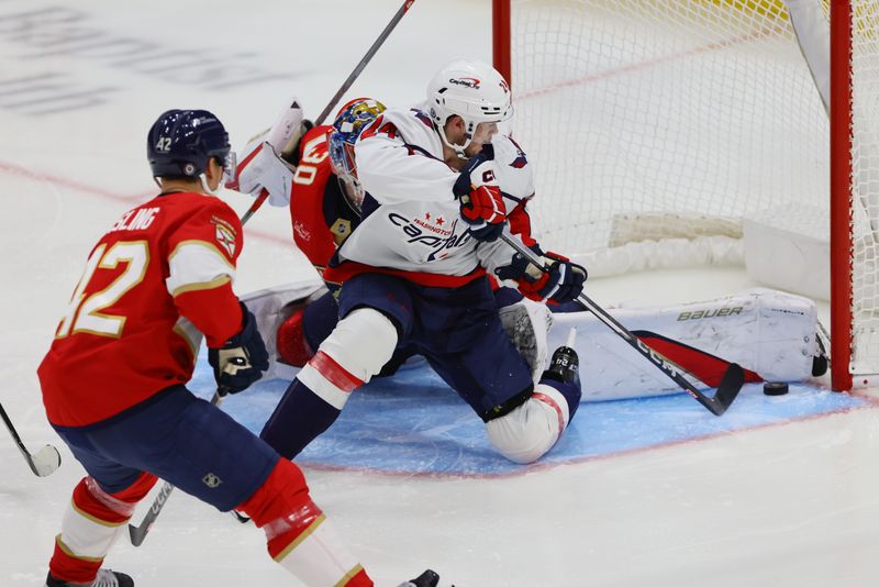 Nov 25, 2024; Sunrise, Florida, USA; Florida Panthers goaltender Spencer Knight (30) makes a save against Washington Capitals center Connor McMichael (24) during the third period at Amerant Bank Arena. Mandatory Credit: Sam Navarro-Imagn Images