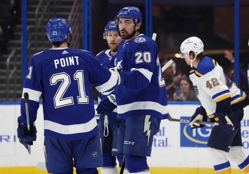 Dec 19, 2023; Tampa, Florida, USA; Tampa Bay Lightning left wing Nicholas Paul (20) is congratulated after scoring against the St. Louis Blues during the third period at Amalie Arena. Mandatory Credit: Kim Klement Neitzel-USA TODAY Sports