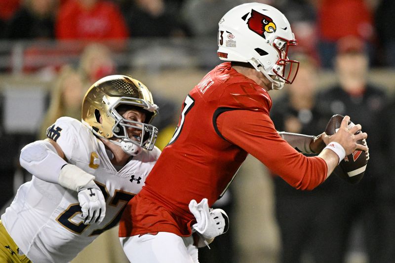 Oct 7, 2023; Louisville, Kentucky, USA; Notre Dame Fighting Irish linebacker JD Bertrand (27) sacks Louisville Cardinals quarterback Jack Plummer (13) during the first half at L&N Federal Credit Union Stadium. Mandatory Credit: Jamie Rhodes-USA TODAY Sports