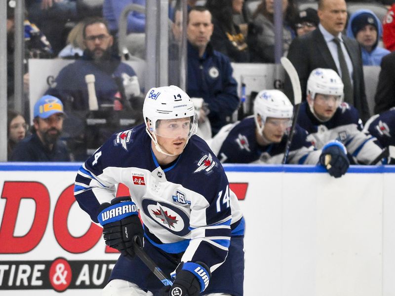 Dec 17, 2025; St. Louis, Missouri, USA; Winnipeg Jets right wing Gustav Nyquist (14) controls the puck against the St. Louis Blues during the first period at Enterprise Center. Mandatory Credit: Jeff Curry-Imagn Images