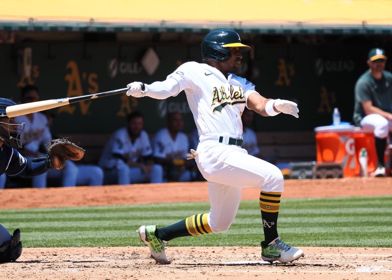 Jun 15, 2023; Oakland, California, USA; Oakland Athletics second baseman Tony Kemp (5) hits a single against the Tampa Bay Rays during the third inning at Oakland-Alameda County Coliseum. Mandatory Credit: Kelley L Cox-USA TODAY Sports