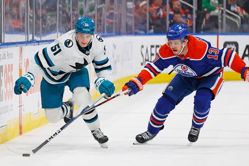 Apr 15, 2024; Edmonton, Alberta, CAN; San Jose Sharks forward Collin Graf (51) and Edmonton Oilers forward Mattias Janmark (13) chase a loose puck during the second period at Rogers Place. Mandatory Credit: Perry Nelson-USA TODAY Sports