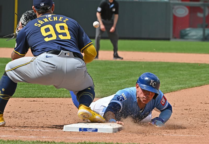 May 8, 2024; Kansas City, Missouri, USA;  Kansas City Royals catcher Freddy Fermin (34) dives back into first base safely against Milwaukee Brewers first baseman Gary Sanchez (99) in the seventh inning at Kauffman Stadium. Mandatory Credit: Peter Aiken-USA TODAY Sports