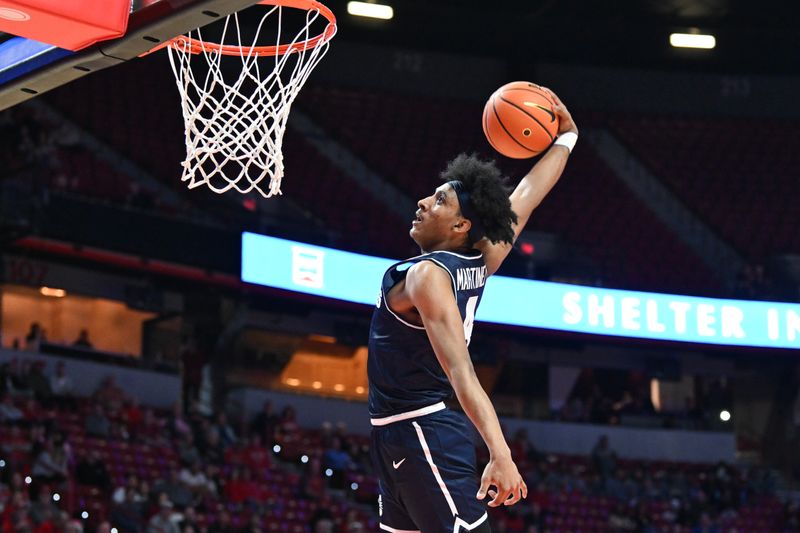 Jan 13, 2024; Las Vegas, Nevada, USA; Utah State Aggies guard Ian Martinez (4) dunks on the UNLV Rebels in the second half at Thomas & Mack Center. Mandatory Credit: Candice Ward-USA TODAY Sports