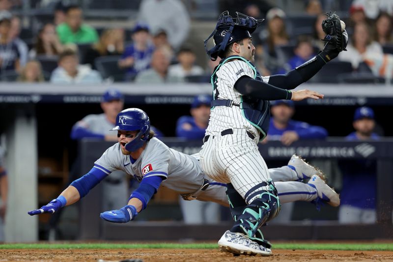 Sep 9, 2024; Bronx, New York, USA; Kansas City Royals shortstop Bobby Witt Jr. (7) scores a run against New York Yankees catcher Austin Wells (28) on a single by Royals catcher Salvador Perez (not pictured) during the fifth inning at Yankee Stadium. Mandatory Credit: Brad Penner-Imagn Images