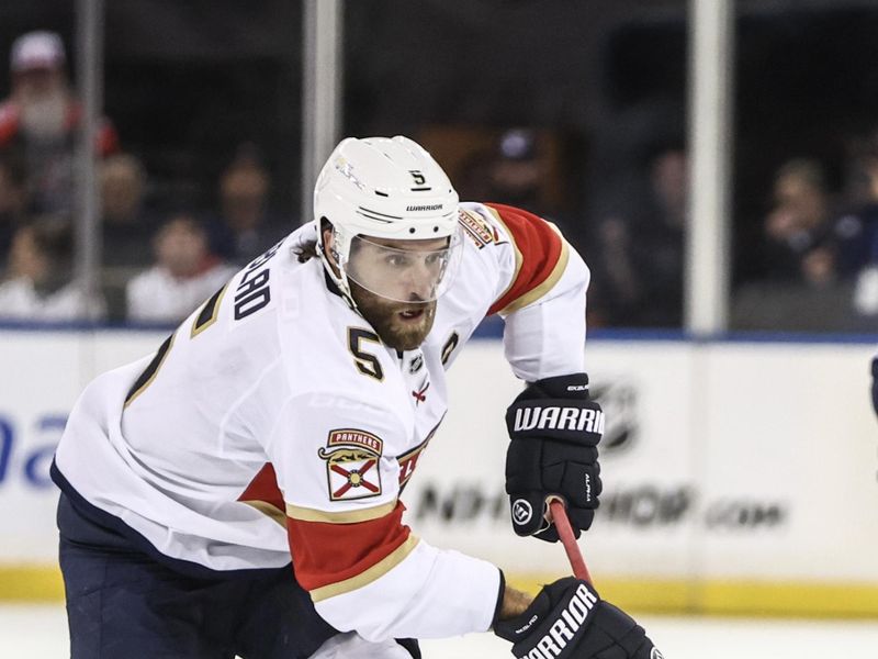 Oct 24, 2024; New York, New York, USA;  Florida Panthers defenseman Aaron Ekblad (5) controls the puck in the first period against the New York Rangers at Madison Square Garden. Mandatory Credit: Wendell Cruz-Imagn Images