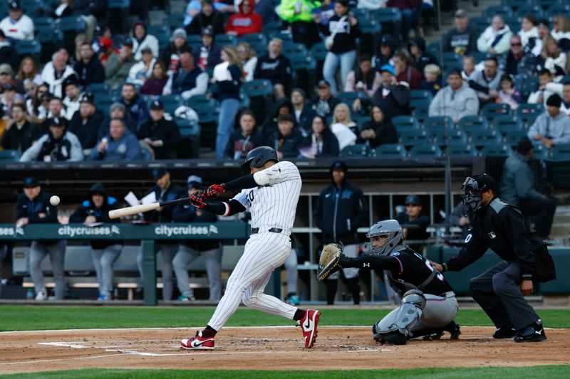 May 10, 2025; Chicago, Illinois, USA; Chicago White Sox second baseman Lenyn Sosa (50) singles against the Miami Marlins during the second inning at Rate Field. Mandatory Credit: Kamil Krzaczynski-Imagn Images