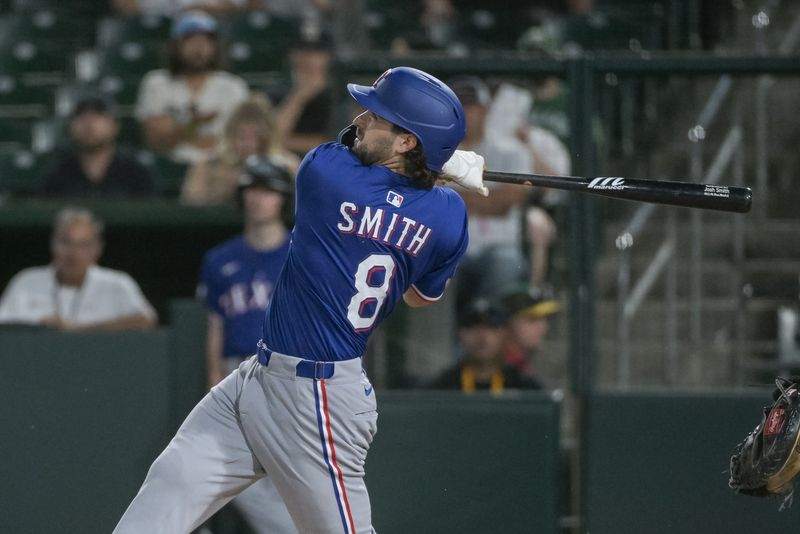 Apr 22, 2025; West Sacramento, California, USA; Texas Rangers third base Josh Smith (8) hits a home run against the Athletics during the fifth inning at Sutter Health Park. Mandatory Credit: Ed Szczepanski-Imagn Images