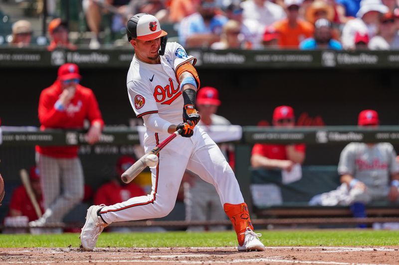 Jun 16, 2024; Baltimore, Maryland, USA; Baltimore Orioles third baseman Ramon Urias (29) hits a single against the Philadelphia Phillies during the fourth inning at Oriole Park at Camden Yards. Mandatory Credit: Gregory Fisher-USA TODAY Sports