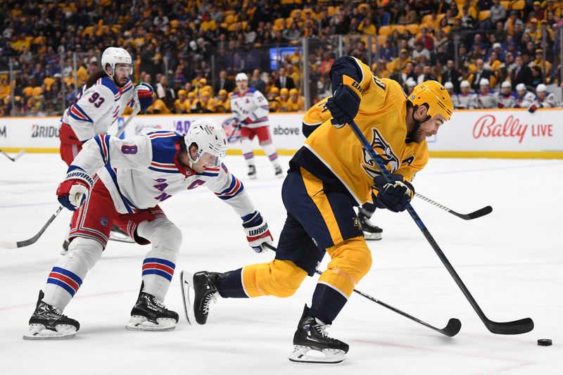 Dec 2, 2023; Nashville, Tennessee, USA; Nashville Predators center Ryan O'Reilly (90) handles the puck against New York Rangers defenseman Jacob Trouba (8) during the first period at Bridgestone Arena. Mandatory Credit: Christopher Hanewinckel-USA TODAY Sports