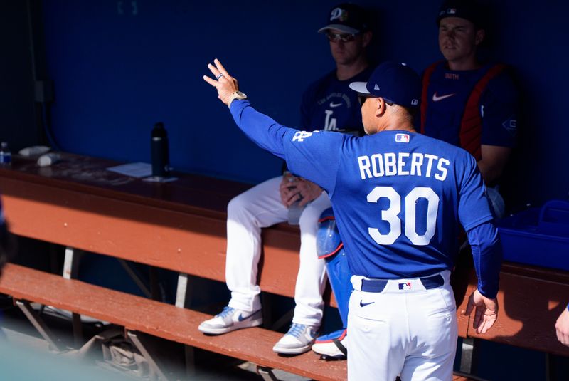 Feb 28, 2026; Phoenix, Arizona, USA; Los Angeles Dodgers manager Dave Roberts (30) greets his team upon arriving in the dugout for a spring training game against the Chicago Cub at Camelback Ranch-Glendale. Mandatory Credit: Allan Henry-Imagn Images