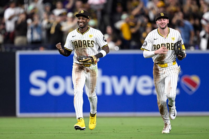 Sep 21, 2024; San Diego, California, USA; San Diego Padres left fielder Jurickson Profar (left) celebrates after a diving catch to end the top of the seventh inning against the Chicago White Sox at Petco Park. Mandatory Credit: Orlando Ramirez-Imagn Images