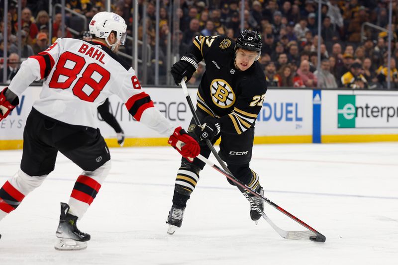 Jan 15, 2024; Boston, Massachusetts, USA; New Jersey Devils defenseman Kevin Bahl (88) gets his stick on a shot by Boston Bruins defenseman Hampus Lindholm (27) during the first period at TD Garden. Mandatory Credit: Winslow Townson-USA TODAY Sports