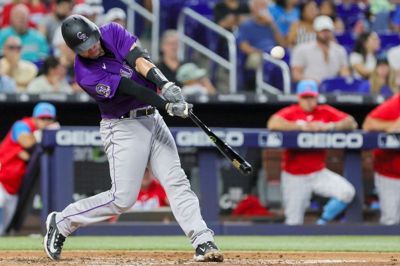 Jul 22, 2023; Miami, Florida, USA; Colorado Rockies catcher Austin Wynns (16) hits a double against the Miami Marlins during the third inning at loanDepot Park. Mandatory Credit: Sam Navarro-USA TODAY Sports