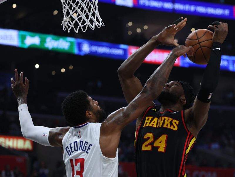 LOS ANGELES, CALIFORNIA - MARCH 17: Bruno Fernando #24 of the Atlanta Hawks loses the ball in front of Paul George #13 of the LA Clippers during a 110-93 Hawks win at Crypto.com Arena on March 17, 2024 in Los Angeles, California. (Photo by Harry How/Getty Images) User is consenting to the terms and conditions of the Getty Images License Agreement.  (Photo by Harry How/Getty Images)