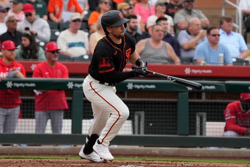 Feb 26, 2024; Scottsdale, Arizona, USA; San Francisco Giants right fielder Chase Pinder (65) hits a single against the Los Angeles Angels in the second inning at Scottsdale Stadium. Mandatory Credit: Rick Scuteri-USA TODAY Sports