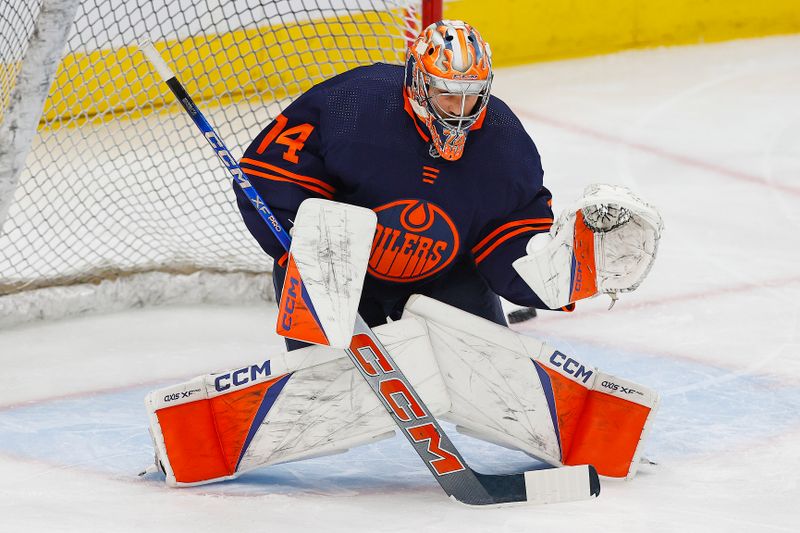 Nov 2, 2023; Edmonton, Alberta, CAN;  Edmonton Oilers goaltender Stuart Skinner (74) makes a save during warmup against the Dallas Stars at Rogers Place. Mandatory Credit: Perry Nelson-USA TODAY Sports