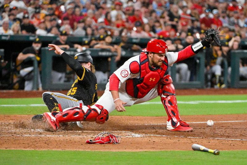 Jun 11, 2024; St. Louis, Missouri, USA;  St. Louis Cardinals catcher Pedro Pages (43) is unable to field the throw from shortstop Masyn Winn (not pictured) allowing Pittsburgh Pirates center fielder Jack Suwinski (65) to score during the ninth inning at Busch Stadium. Mandatory Credit: Jeff Curry-USA TODAY Sports