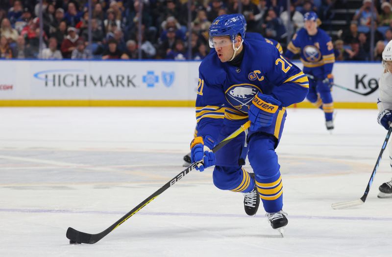 Dec 21, 2023; Buffalo, New York, USA;  Buffalo Sabres right wing Kyle Okposo (21) skates with the puck during the second period against the Toronto Maple Leafs at KeyBank Center. Mandatory Credit: Timothy T. Ludwig-USA TODAY Sports