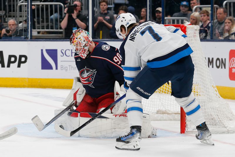 Mar 17, 2024; Columbus, Ohio, USA; Columbus Blue Jackets goalie Elvis Merzlikins (90) makes a save as Winnipeg Jets center Vladislav Namestnikov (7) looks for a rebound during the third period at Nationwide Arena. Mandatory Credit: Russell LaBounty-USA TODAY Sports